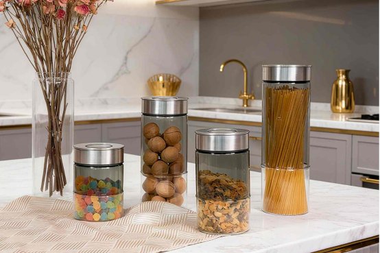 Fluted glass storage jars with acacia wood lids holding coffee beans grains and pasta
